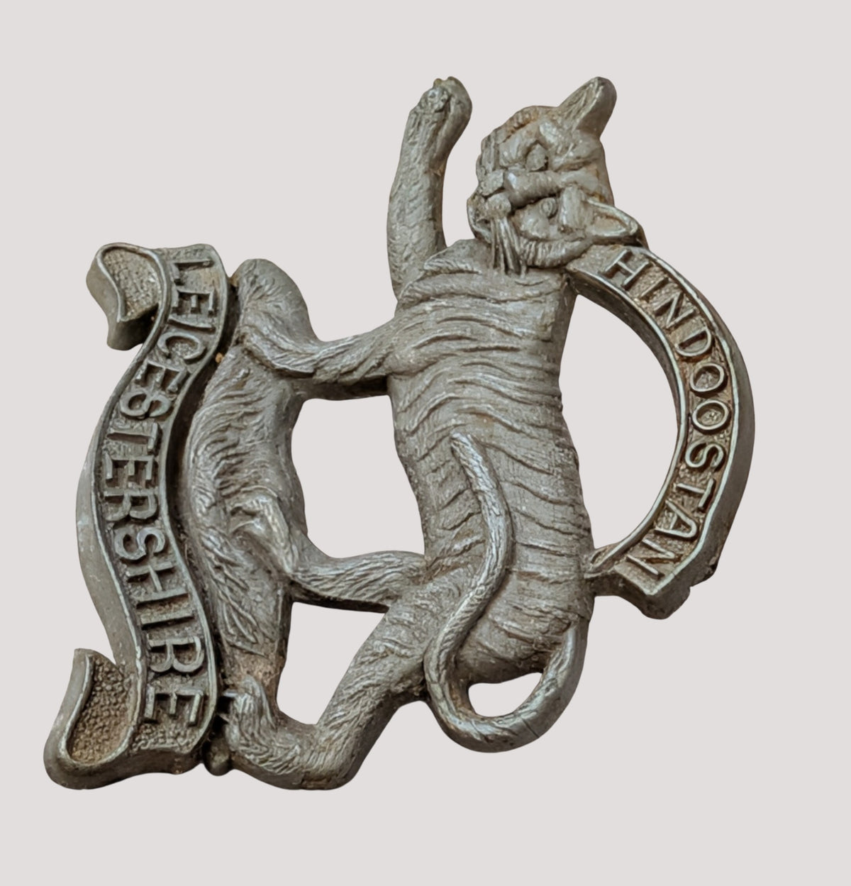 WW2 Plastic Economy Leicestershire Regiment Cap Badge with blades